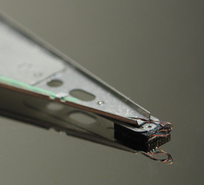 This is a close up picture of the Read-Write Head floating over a healthy Hard Disk Platter.